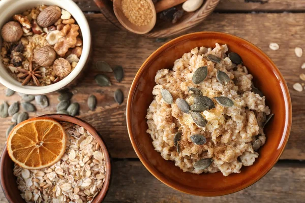 Bowls Tasty Oatmeal Nuts Wooden Table — Stock Photo, Image