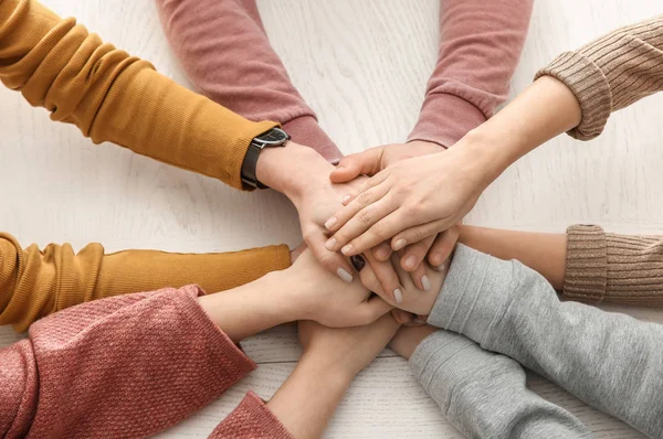 Grupa Ludzi Łącząc Ręce Przy Stole — Zdjęcie stockowe