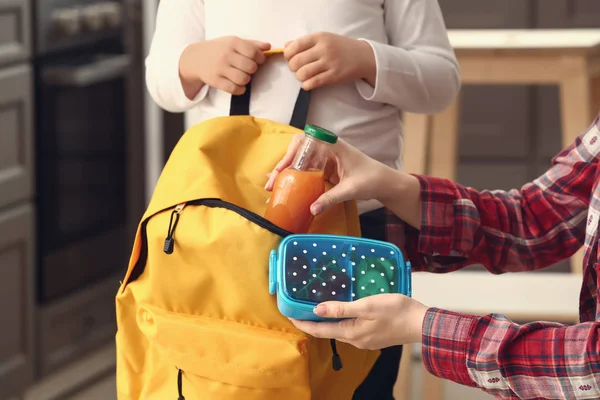 Mother Putting Lunch Box Backpack Her Little Son School — Stock Photo, Image