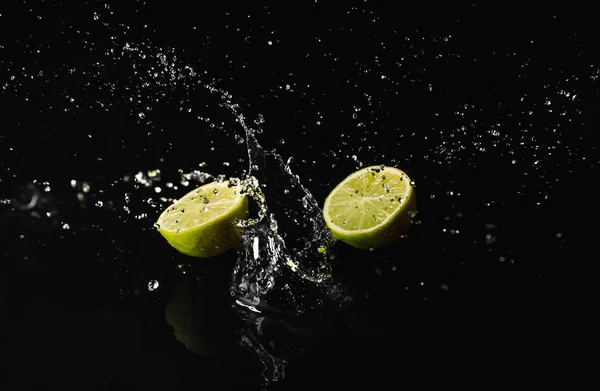 Ripe Cut Lime Water Splash Dark Background Royalty Free Stock Images