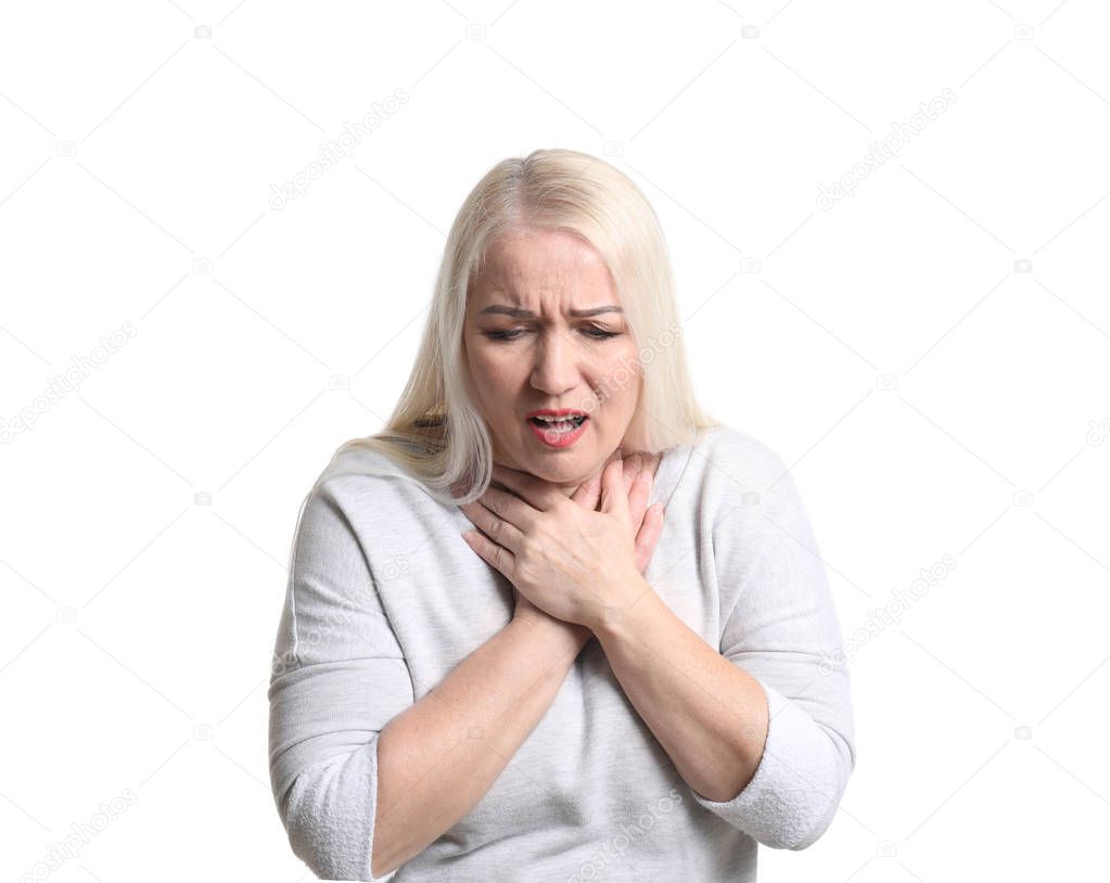 Mature woman having asthma attack on white background