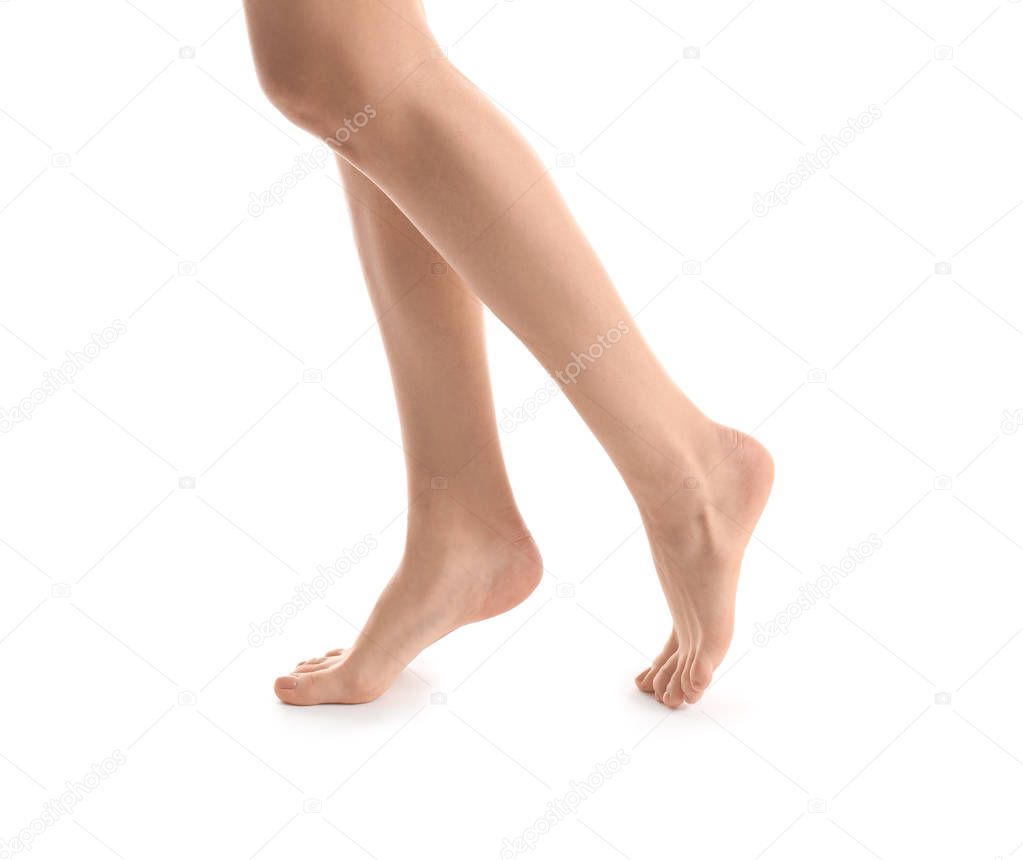 Legs of young woman with beautiful pedicure on white background