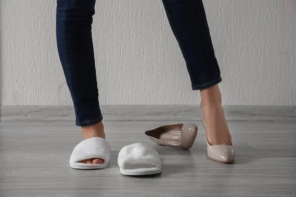 Young Woman Choosing Slippers High Heeled Shoes White Wall — Stock Photo, Image