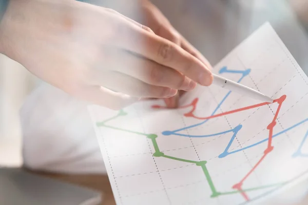 Man with diagram during business meeting in office, closeup