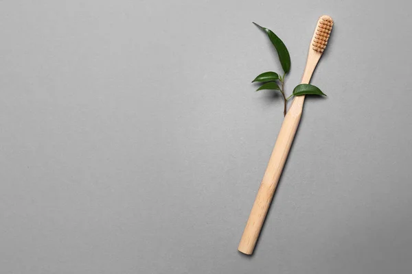 Wooden Toothbrush Green Leaves Grey Background Ecology Concept — Stock Photo, Image