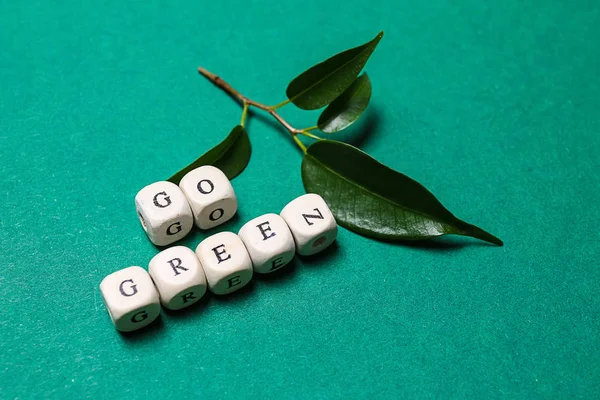 Cubes with text GO GREEN on color background