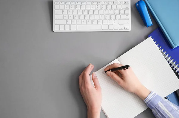 Mani Femminili Che Scrivono Qualcosa Nel Quaderno Sfondo Grigio — Foto Stock