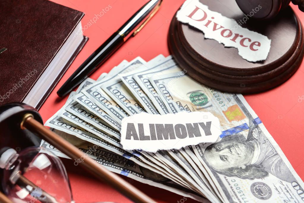 Composition with words ALIMONY and DIVORCE with money on color background