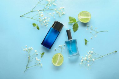 Şişe parfüm, çiçekler ve narenciye meyve renk arka plan üzerinde