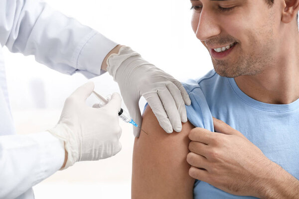 Doctor Vaccinating Male Patient Clinic Stock Picture