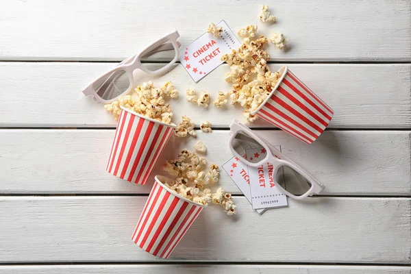 Overturned Paper Cups Tasty Popcorn Cinema Tickets Glasses Wooden Background — Stock Photo, Image