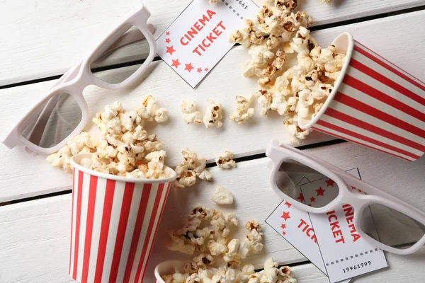 Overturned Paper Cups Tasty Popcorn Cinema Tickets Glasses Wooden Background — Stock Photo, Image