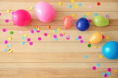 Ahşap zemin üzerine konfeti ile doğum günü balonları