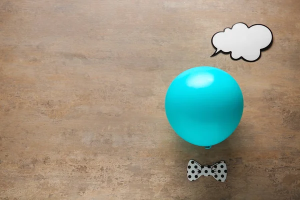 Funny balloon on grey background