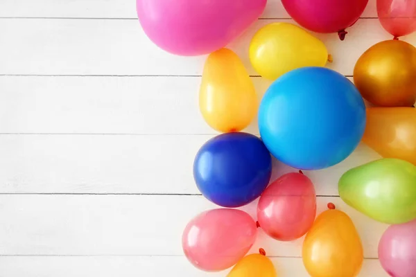 Kleurrijke Ballonnen Witte Houten Achtergrond — Stockfoto