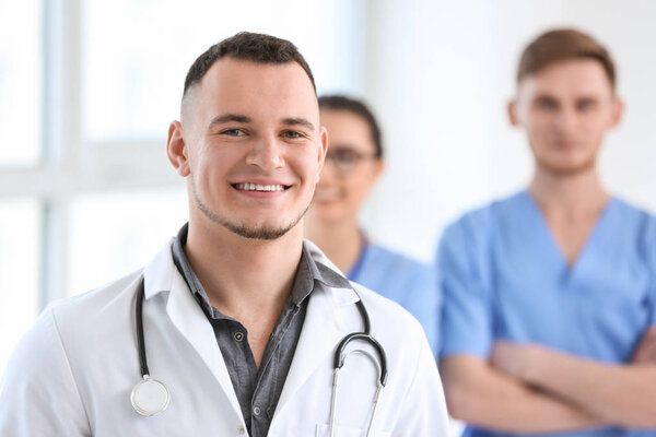 Male doctor and his colleagues in clinic