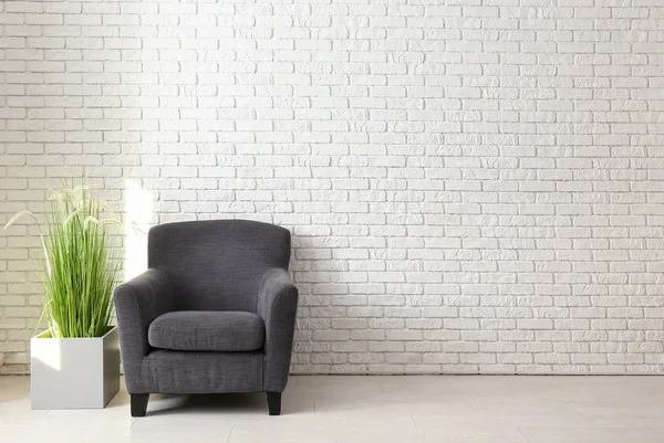 白いレンガの壁の近くの快適なアームチェア — ストック写真