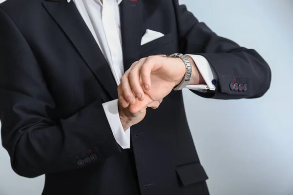 Handsome Fashionable Man Formal Clothes Looking Watch Light Background Closeup — Stock Photo, Image