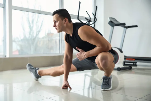 Sporty young man training in gym