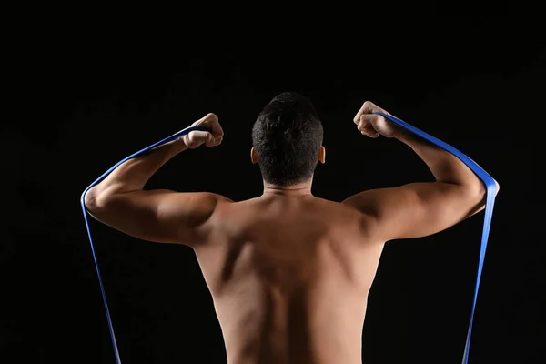 Sporty Young Man Training Resistance Band Dark Background — Stock Photo, Image