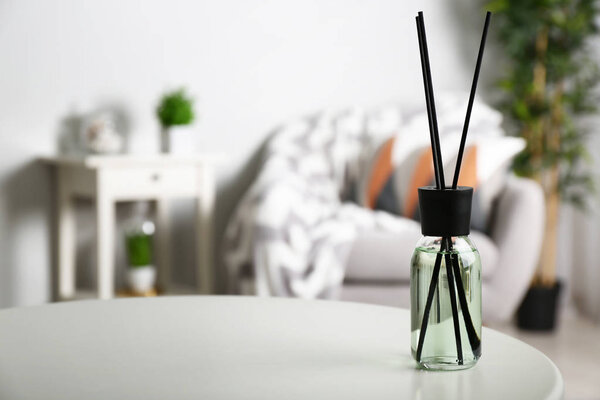 Reed diffuser on table in room