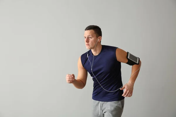 Sporty Young Man Running Light Background — Stock Photo, Image