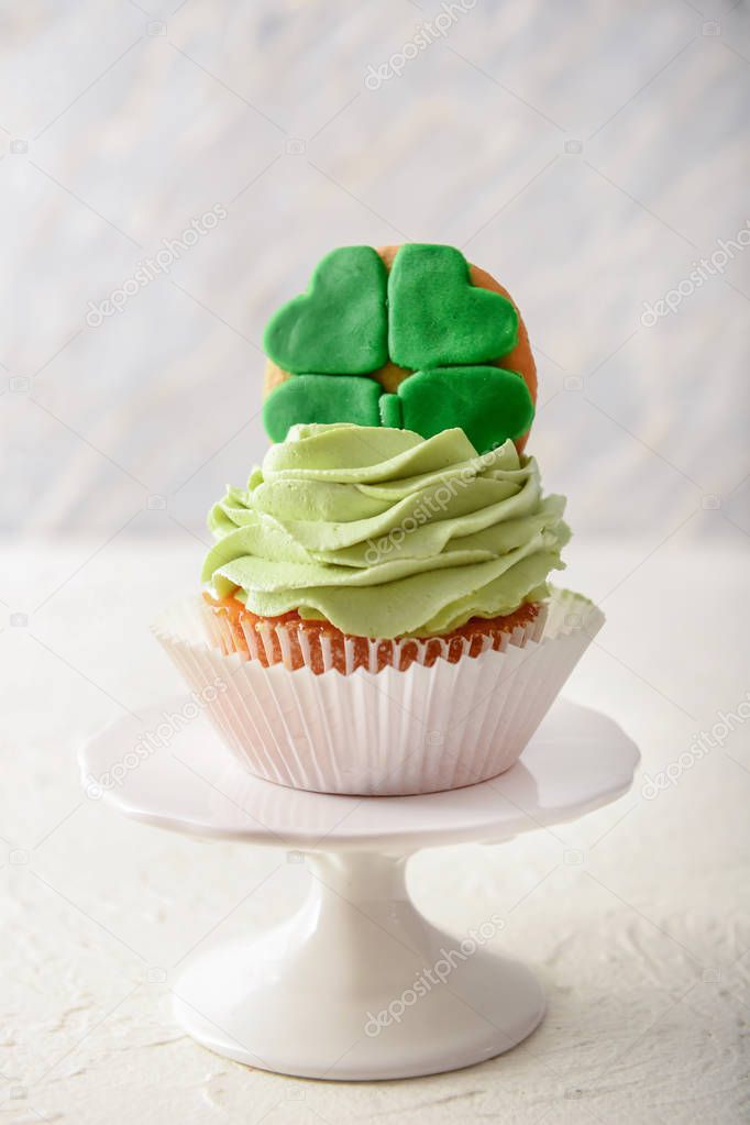 Tasty cupcake for St. Patrick's Day celebration on white table