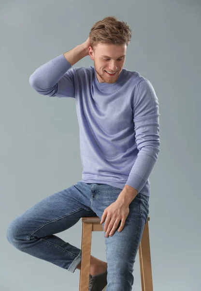 Fashionable Young Man Sitting Stool Grey Background — Stock Photo, Image