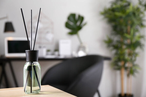 Reed diffuser on table in room