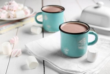 Beyaz masa üzerinde marshmallows içkiyle sıcak kakao bir fincan