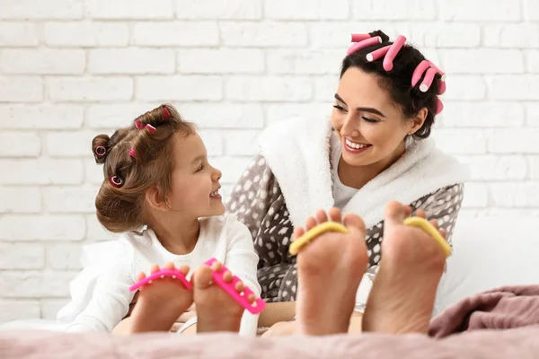 Niedliche Tochter Mit Mutter Die Pediküre Und Lockenhaare Hause Macht — Stockfoto