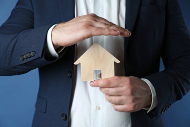 Renk arka plan, closeup şirketten figürü tutan sigortacı