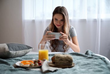 Yiyecek fotoğrafçı ile cep telefonu evde lezzetli breakfast resim çekmek