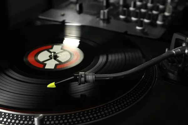 Vinyl disk on modern DJ mixer, closeup