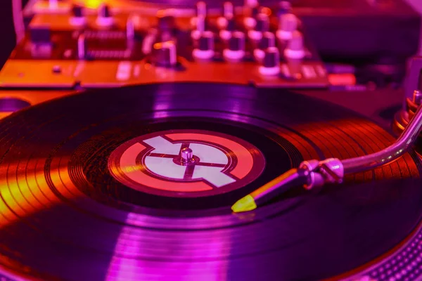 Vinyl disk on modern DJ mixer, closeup