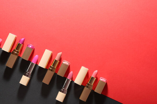 Different lipsticks on color background