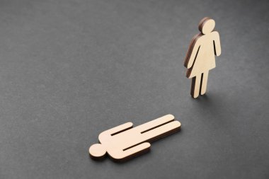 Female and male figures on dark background. Concept of transgender clipart