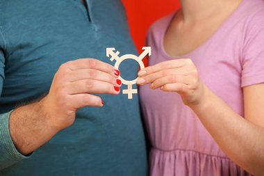 Man and woman showing symbol of transgender on color background, closeup clipart