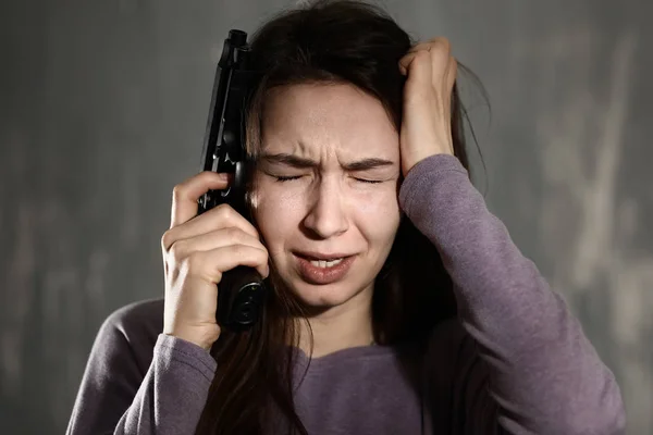 Young Depressed Woman Gun Thinking Suicide Grey Background — Stock Photo, Image