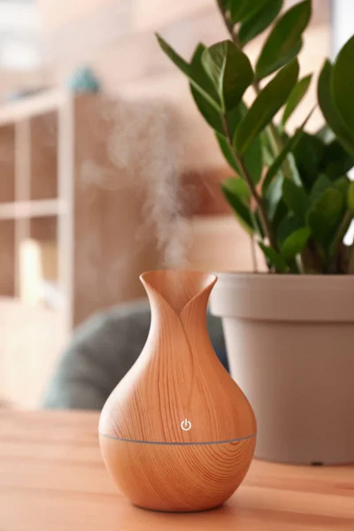Aroma oil diffuser on table in room