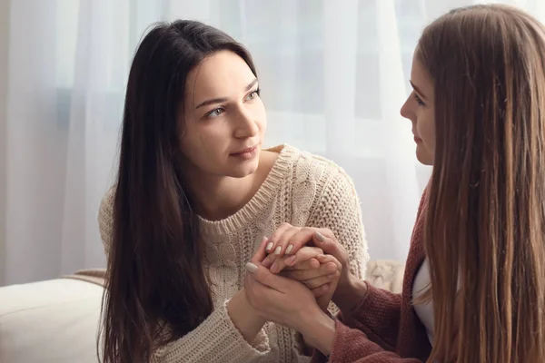 Friend helping young depressed woman at home. Stop a suicide