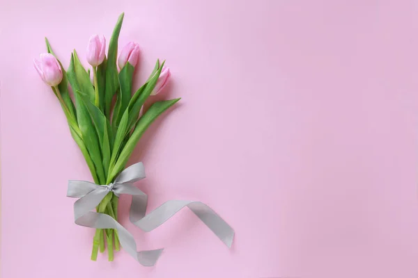 Bouquet of beautiful tulips on color background