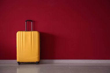 Renkli duvarın yanında paketlenmiş bavul