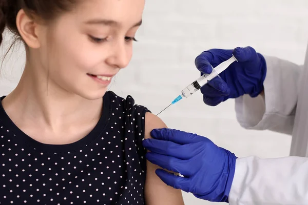 Läkare vaccinerande barn mot influensa i klinik — Stockfoto