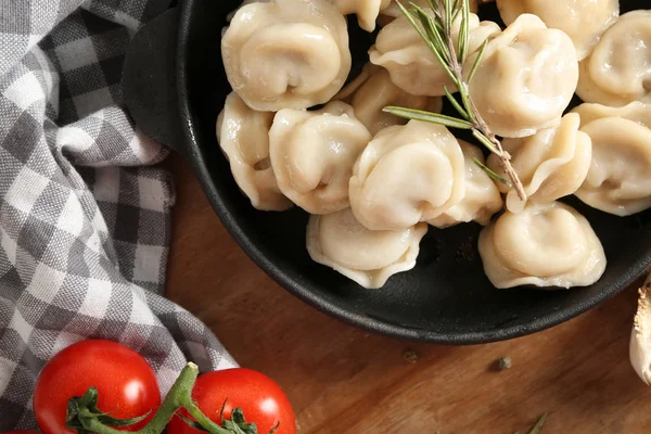 Tasty dumplings in pan on table — Stock Photo, Image