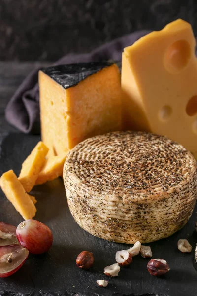 Assortment of tasty cheese on slate plate — Stock Photo, Image