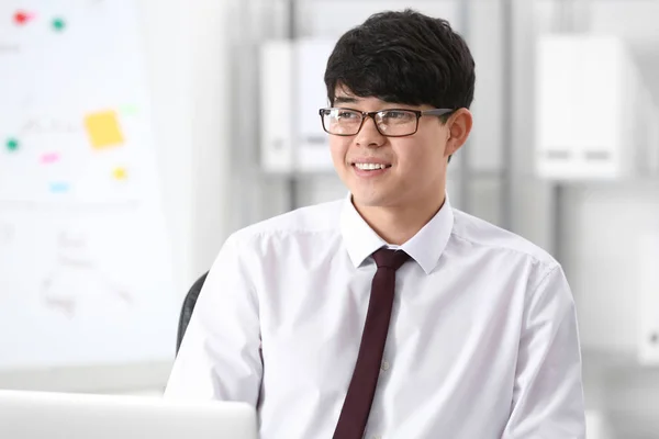 Young Asian businessman at meeting in office — Stock Photo, Image