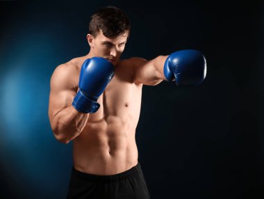 Koyu arka plan üzerinde çekici genç boksör