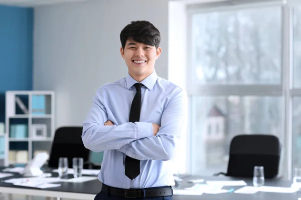 Young Asian businessman at meeting in office — Stock Photo, Image
