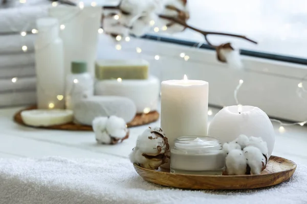 Beautiful burning candles with jar of cream on windowsill — Stock Photo, Image